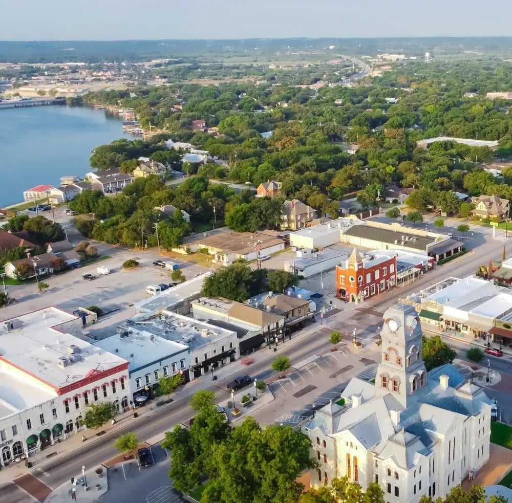 Aerial view of a town with a clock tower near a lake